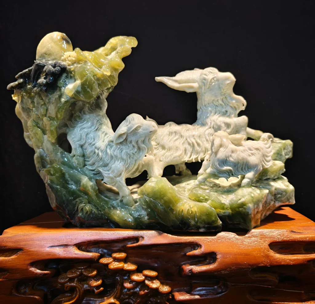 A green mountain-shaped art object with carved surface detail.