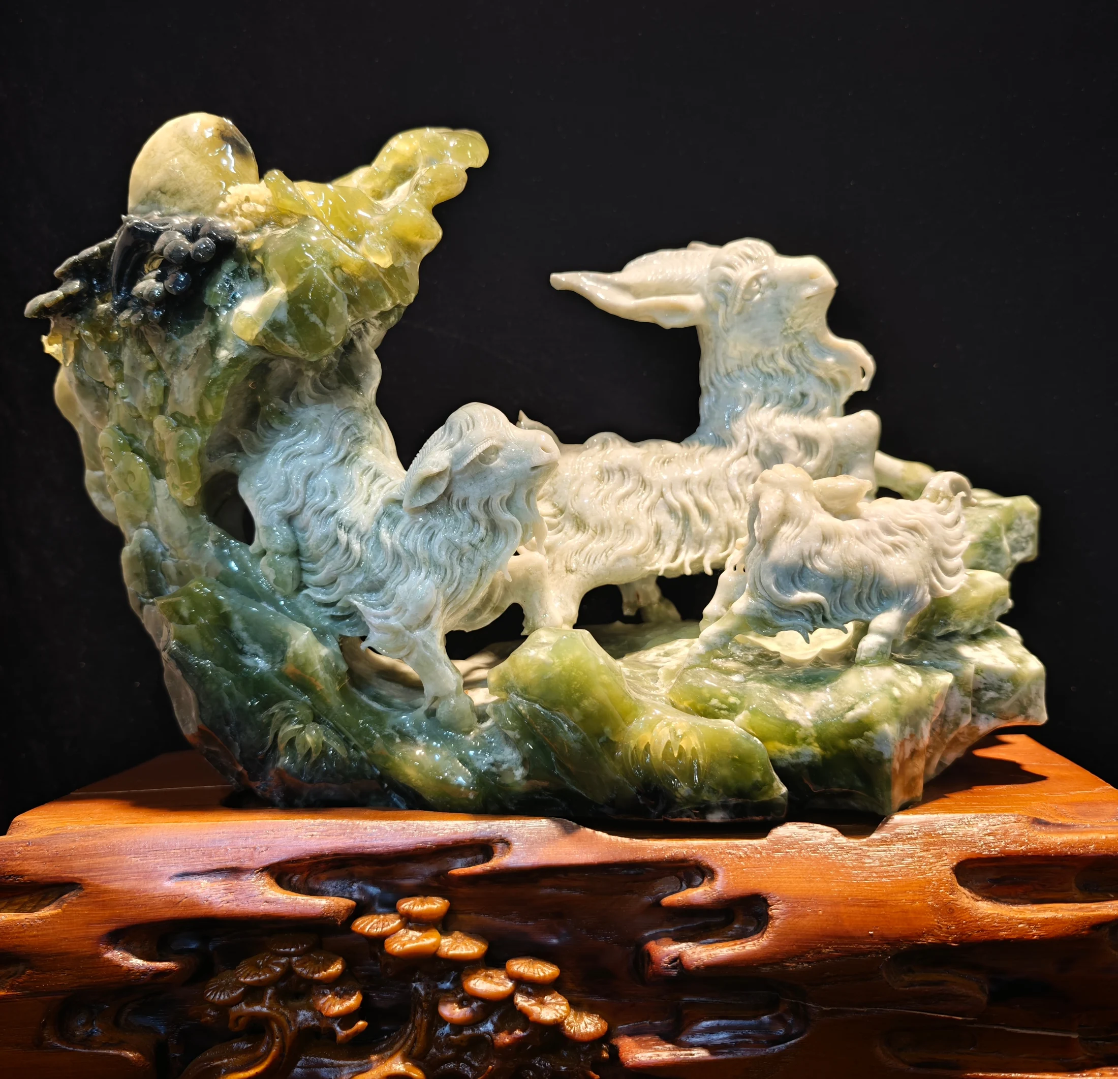 A green mountain-shaped art object with carved surface detail.