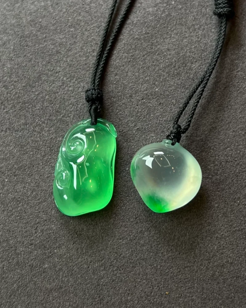 Twin Green Forms paired pendants on black cords, view 1